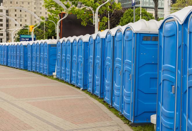 a row of portable restrooms set up for a large athletic event, allowing participants and spectators to easily take care of their needs in Newtown, CT